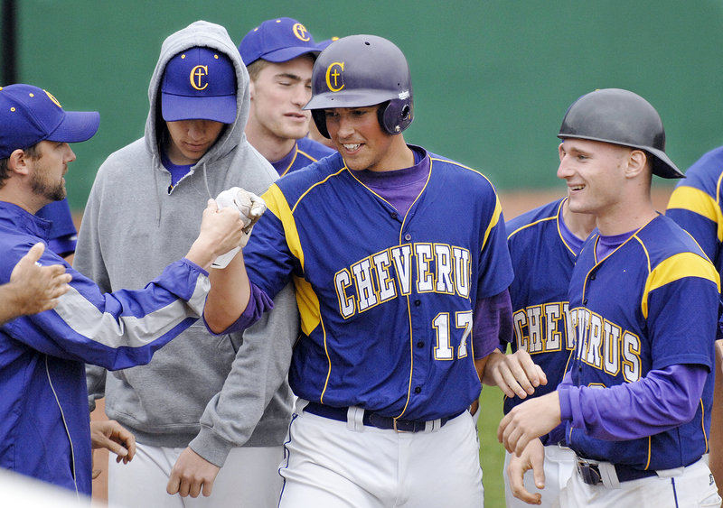 Joey Royer is greeted by his Cheverus teammates after scoring Monday in the Stags’ 8-2 win over South Portland in their regional ‘A’ semifinal.