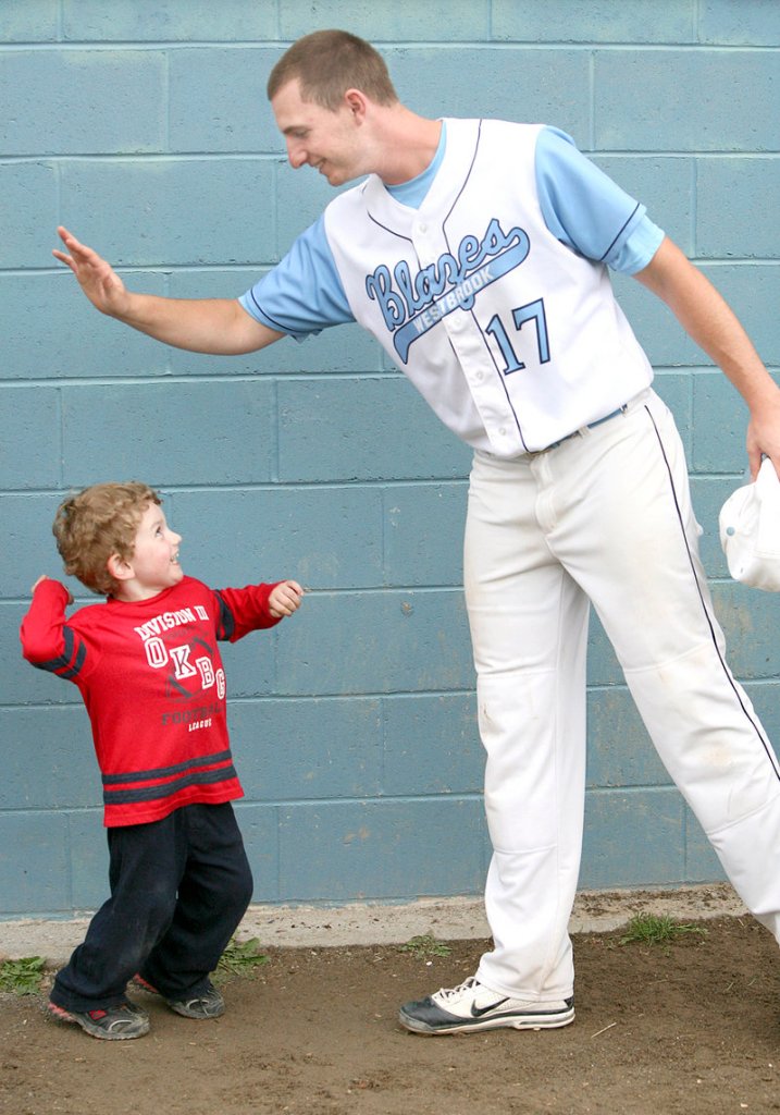 Cam Gardiner, 3, high-fives his uncle, Zach Gardiner, after Westbrook defeated Marshwood 2-1 in a Western Class A baseball semifinal Monday in Westbrook.