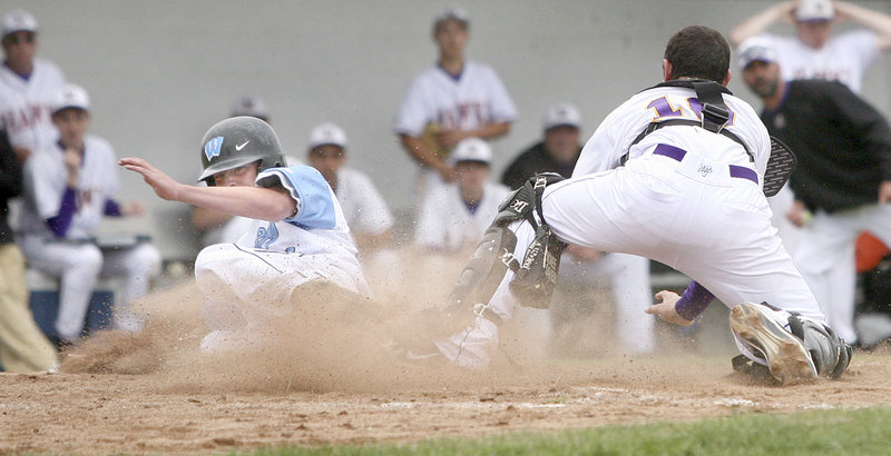 Westbrook’s Kaleb Kent slides past Marshwood catcher Matt Brenner to score the winning run Monday in the sixth inning of their Class A regional semifinal in Westbrook. The Blazes move on to the regional final for the third time in four years. They play Cheverus on Wednesday.