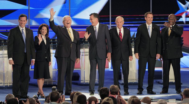 From left, former Pennsylvania Sen. Rick Santorum, Rep. Michele Bachmann, R-Minn., former House Speaker Newt Gingrich, former Massachusetts Gov. Mitt Romney, Rep. Ron Paul, R-Texas, former Minnesota Gov. Tim Pawlenty and businessman Herman Cain stand on stage before the first New Hampshire Republican presidential debate at St. Anselm College in Manchester, N.H., on Monday night.