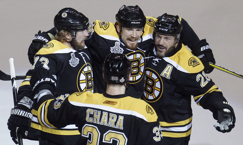 Bruins Zdeno Chara, foreground, Michael Ryder, left, Andrew Ference, center, and Mark Recchi celebrate Ference’s goal in Boston’s four-goal first period Monday night in Boston.