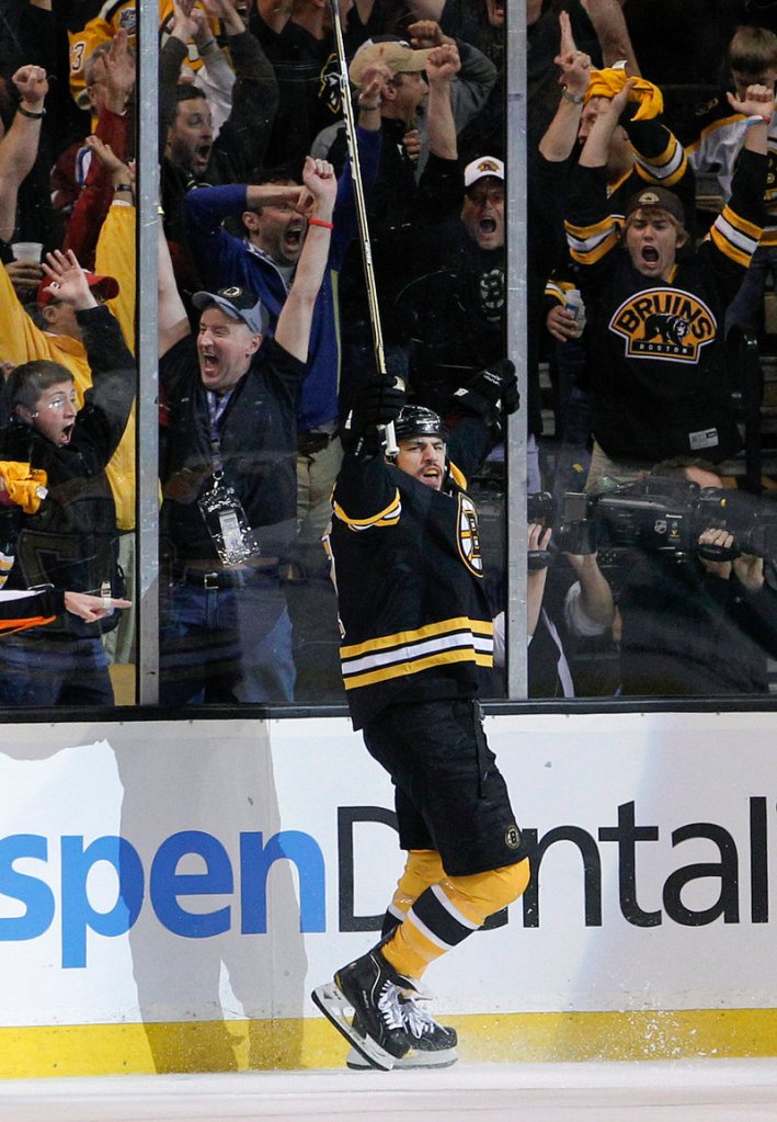 Milan Lucic celebrates his first-period goal. He scored 35 seconds after Brad Marchand for a 2-0 lead.