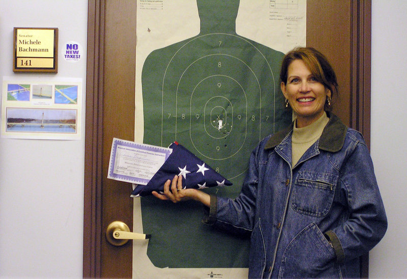 This 2005 photo provided by Michele Bachmann shows then-state Sen. Michele Bachmann as she poses with her state permit to carry a concealed weapon nestled in a folded U.S. flag at her office in the Minnesota Capitol in St. Paul. In Bachmann's quick rise from state lawmaker to unofficial tea party ambassador in Washington, her brazen style has kept Republican leaders on edge and appealed to those in the GOP searching for a fresh, unfettered voice.