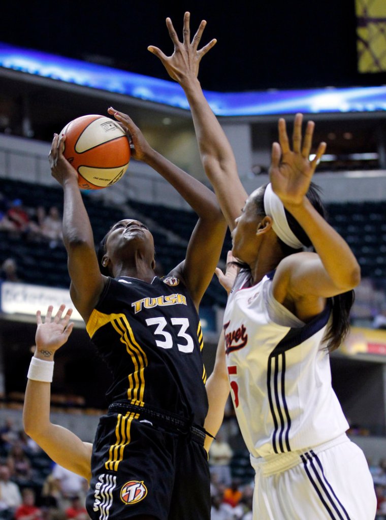 Tiffany Jackson of the Tulsa Shock tries to shoot over Indiana’s Tangela Smith during the Fever’s 82-74 victory Tuesday night.