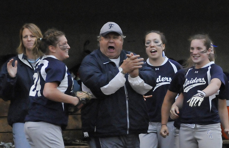 Fryeburg Academy Coach Fred Apt celebrates with his team Tuesday night after getting through an inning in the 6-1 victory against Oak Hill. The Raiders won the Western Class B title for the fourth consecutive season and will play at 11 a.m. Saturday for the state championship.