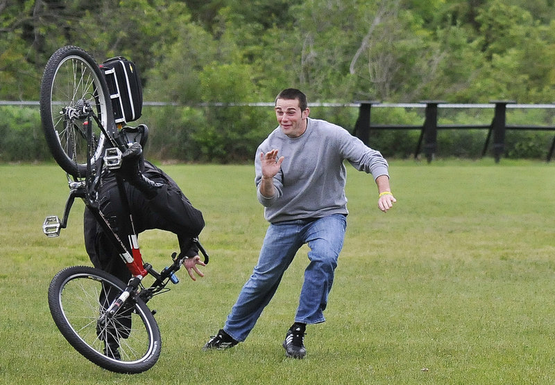 Brian Trefethen, an Ogunquit Police Department reserve officer, dodges the Kennebunk Police Department’s Andrew Bridges, on the bike, during a drill Tuesday at York Middle School.