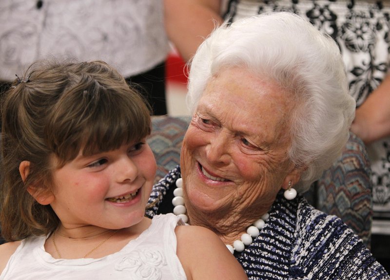 Seven-year-old Mia Trumble sits on Barbara Bush's lap after the former first lady spoke at a ceremony for Literacy Maine on Wednesday in Biddeford. The Barbara Bush Foundation for Family Literacy awards grants to provide quality family literacy programming. As of June 2011, the foundation had awarded more than $40 million to 902 family literacy programs.