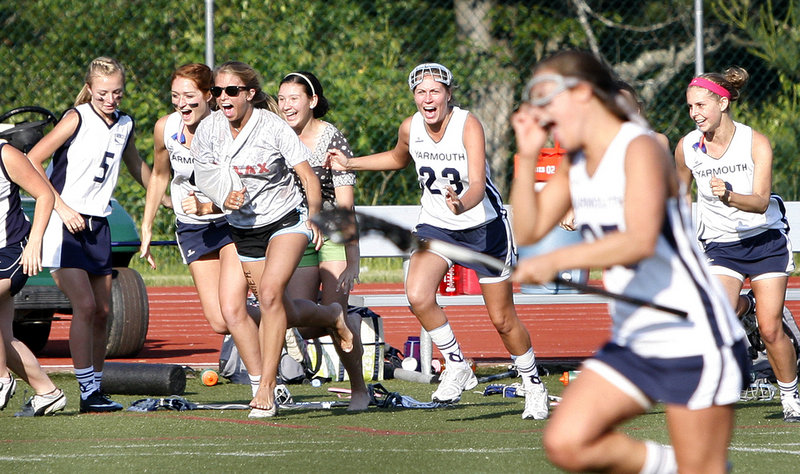 Yarmouth players charge onto the field to celebrate after beating North Yarmouth Academy 6-5 on Wednesday to win the Eastern Class B girls lacrosse championship.