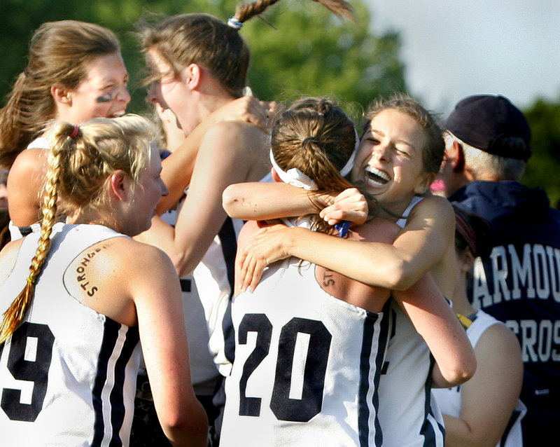 Becca Bell, left, and Kate Dilworth share a hug after Yarmouth earned a spot in the state championship game against Waynflete.