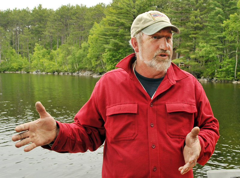 Dale Tobey, vice president of Grand Lake Stream Guides Association, opposes wind turbines on Bowers Mountain, below, which overlooks a multitude of remote lakes prized by fishermen seeking a wilderness experience. The 260-foot-tall meteorological tower visible here is considerably smaller than the wind turbines proposed for the site.