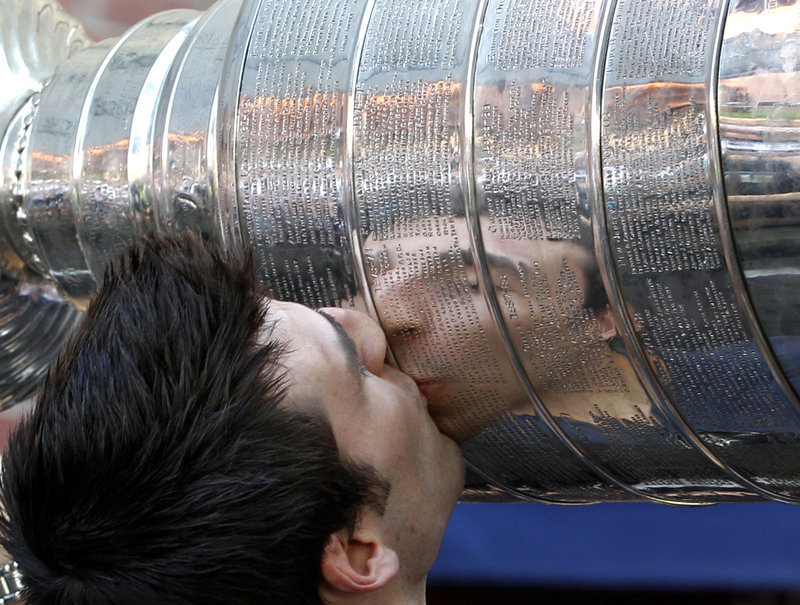The Cup that has seen so many lips got another pair when Patrice Bergeron applied a kiss during the welcome-home for the Boston Bruins.