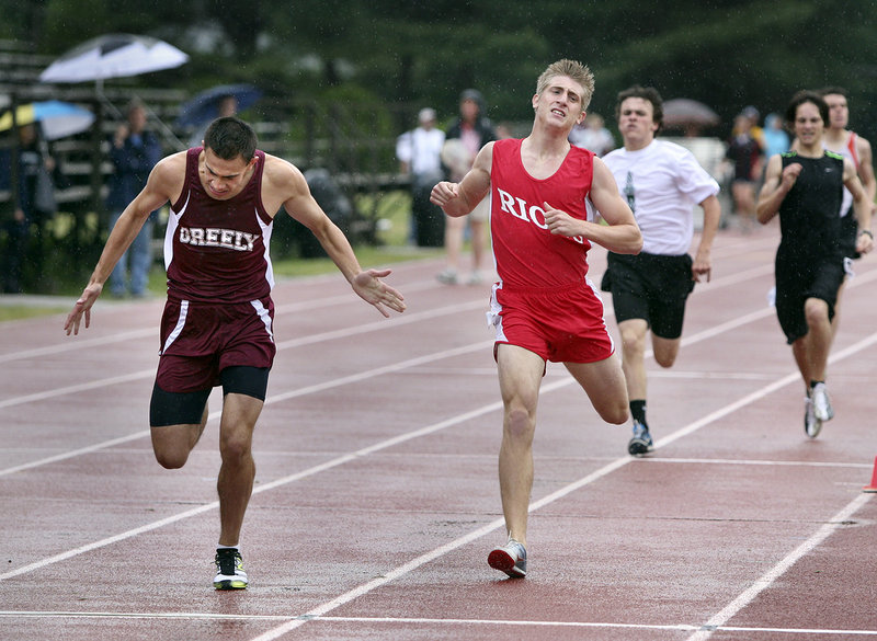 Nestor Taylor of Greely, left, and Matt Clement of South Portland cross the finish after the boys' 800 meter run. Taylor placed second and Clement third.