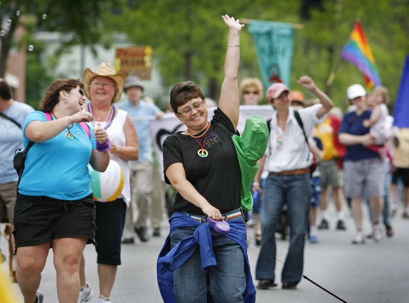 Jubilant participants march down High Street on the way to Deering Oaks Saturday during the 25th annual Southern Maine Pride Parade through Portland. The crowd of about 5,000 was a far cry from the 200 who gathered for the first pride festivities in 1986.