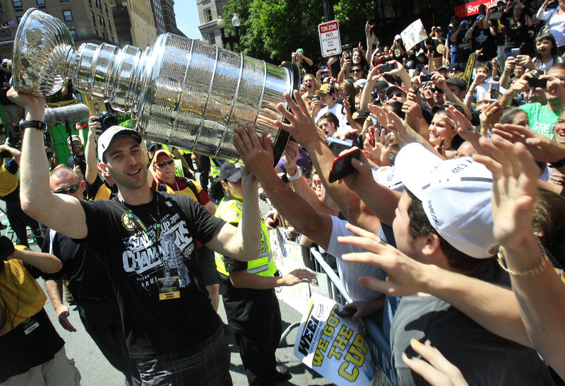 Zdeno Chara left the parade to bring the Stanley Cup to the fans, and a lucky few got the chance to touch it just three days after Boston beat Vancouver in seven games.