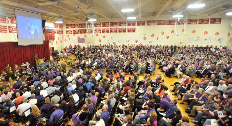 Nearly 1,000 people fill the gymnasium of Dexter Regional High School to remember Amy Lake and her children, Coty and Monica, during a funeral service Saturday. Lake graduated as valedictorian in the same gym.