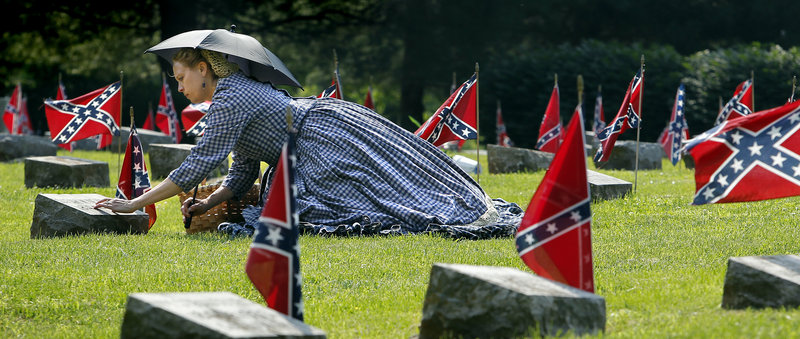Civil War re-enactor Deby Fitzpatrick visits the grave of Sarah Newman, a woman she was portraying in Confederate Memorial Day ceremonies this month at the Confederate Memorial State Historic Site outside Higginsville, Mo.