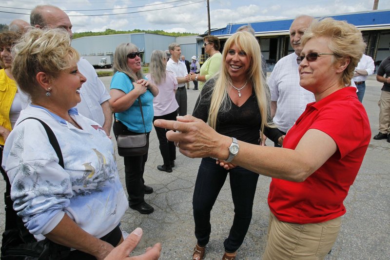 Patriarch Partners CEO Lynn Tilton, center, meets with millworker families June 10 at Gorham Paper and Tissue in Gorham, the last paper mill in New Hampshire’s North Country.
