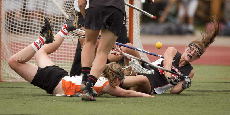 Corrine O'Connor, left, of Brunswick and Maiti Kent of Scarborough fall to the turf while battling for the ball during Scarborough's 13-11 win in the Class A girls' lacrosse final.