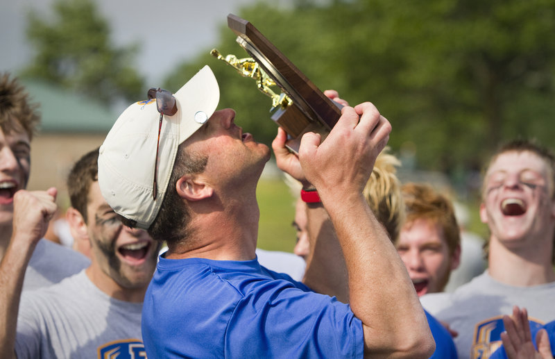 Falmouth Coach Mike Lebel gave more than lip service to winning a state championship. He gave his lips to the trophy Saturday after the Yachtsmen won the Class B boys' lacrosse title for the first time, defeating North Yarmouth Academy 15-3 at Fitzpatrick Stadium.