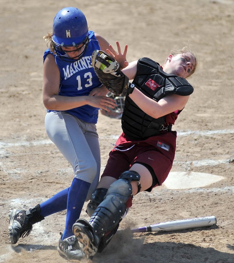 Richmond catcher Lindsy Hoopingarner, right, holds onto the ball as she collides with Deer Isle-Stonington's Chelsea Brown during the Class D state championship game Saturday. The Mariners won the game, 7-2.