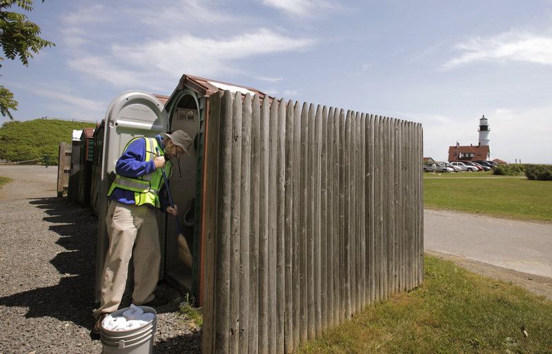 Ray Routhier sweeps out a porta potty at Fort Williams Park in Cape Elizabeth while he learns the duties of a park ranger.