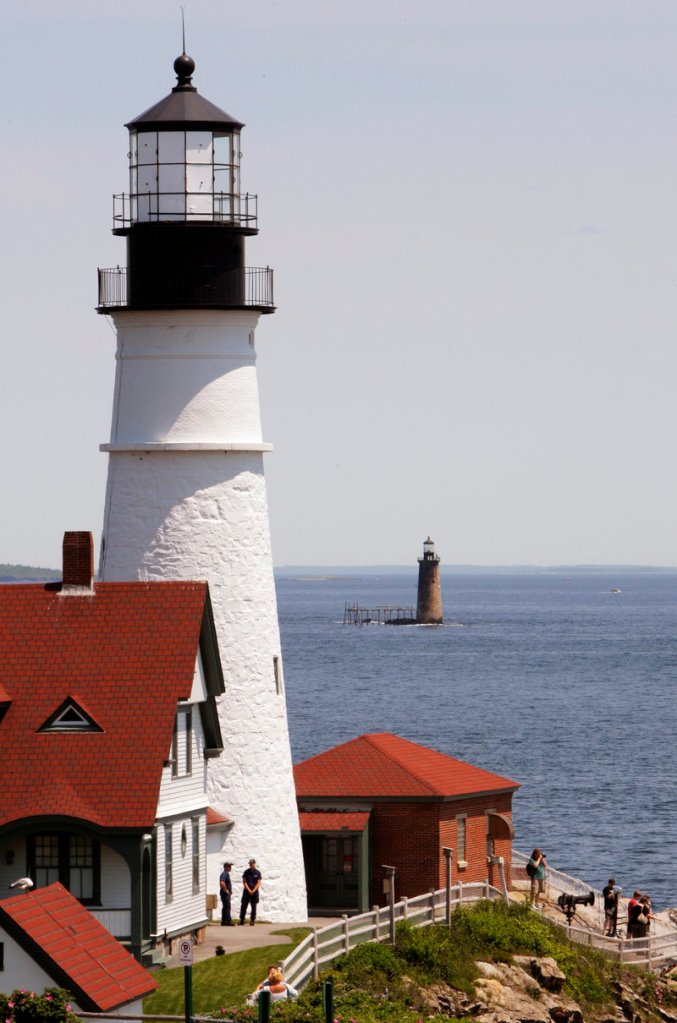 Ram Island Ledge Light, built in 1903-1905, is seen about a mile offshore from its more famous cousin, Portland Head Light in Cape Elizabeth, which is in the foreground.