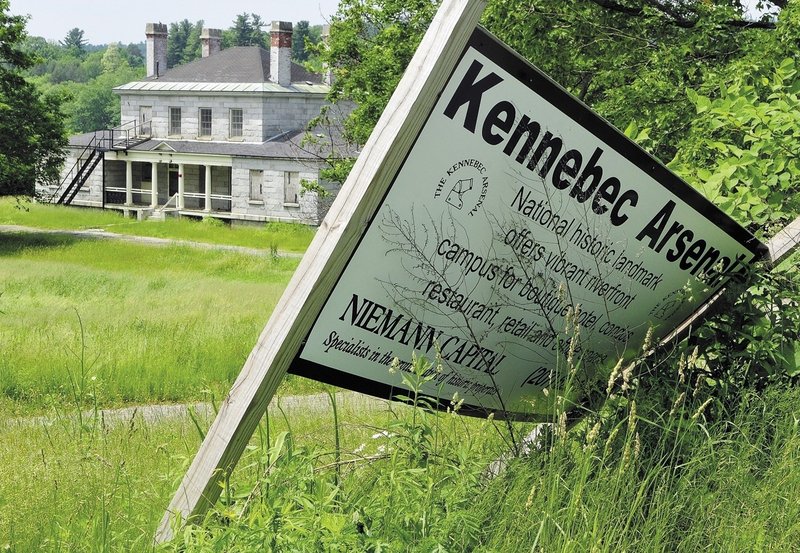 A Niemann Capital sign leans next to the north gate of the Kennebec Arsenal in Augusta. Niemann bought the National Historic Landmark from the state in 2007 with the aim of developing and preserving it, but those plans have stalled.