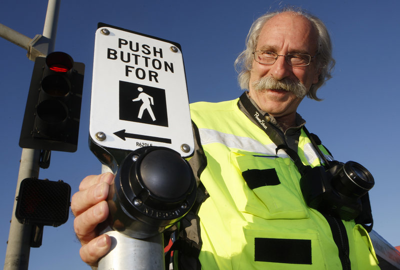 Walking guru Dan Burden checks the response of a pedestrian button for a study on walkability on the streets of Redondo Beach, Calif. Burden recommended putting in a bike lane on a road leading to the Pacific Coast Highway and replacing a car lane with a bike lane in several places to slow down vehicles.
