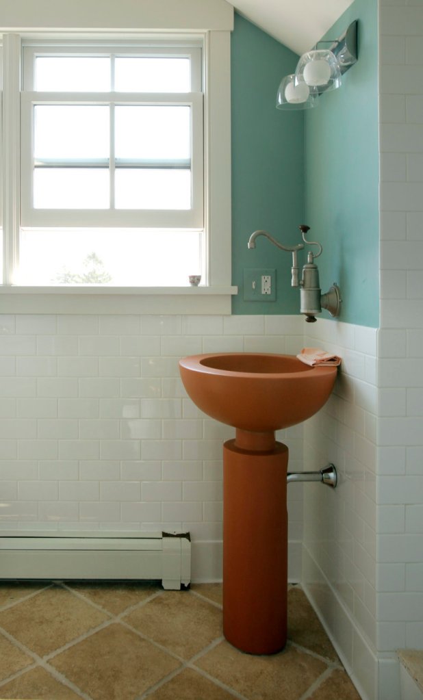 A second-floor bath has a sleek sink and fixtures that make the most of a small space.