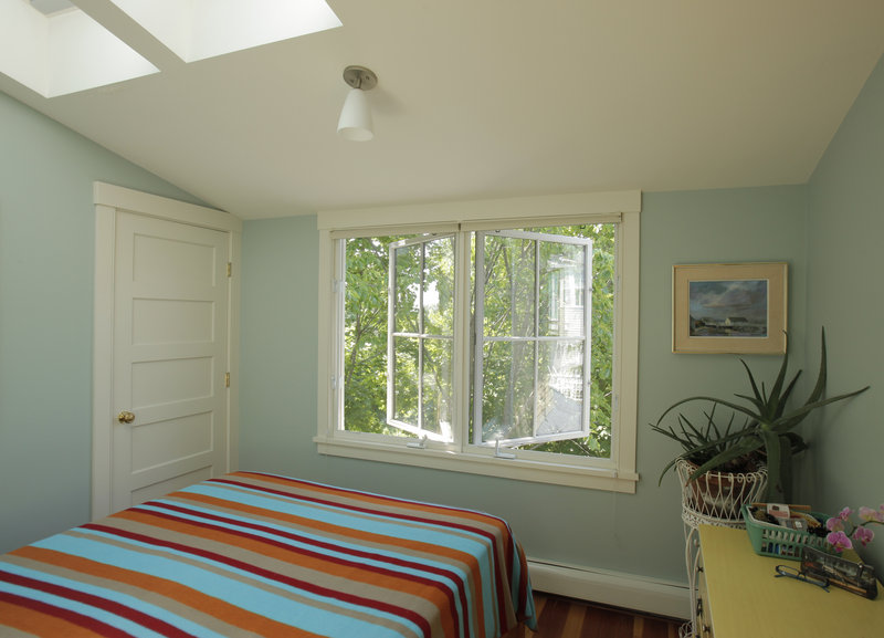 Windows and skylights let in lots of light and air in an upstairs bedroom.