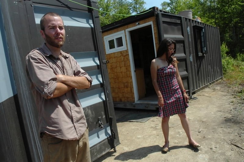 Trevor Seip and Jennifer Sansosti stand outside their shipping container home in Ellsworth. The couple have transformed two 20-foot-long containers – which they bought on the auction website eBay – into their home.