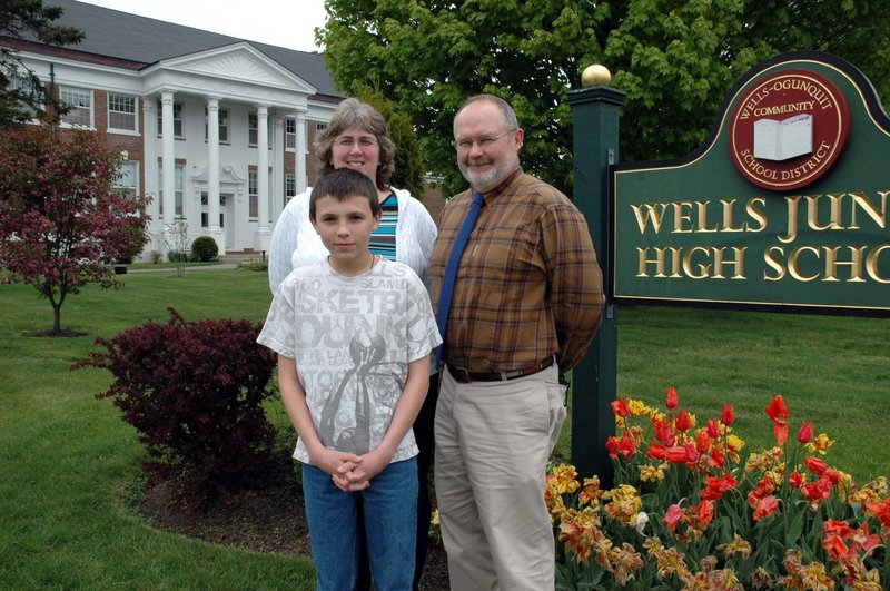 Wells Junior High School eighth-grader Nathan Ouellette poses with the school's gifted and talented teacher, Dawn Valente, and Principal Chris Chessie. Ouellette won a $1,000 scholarship for his participation in a Raytheon-sponsored math advocacy contest.