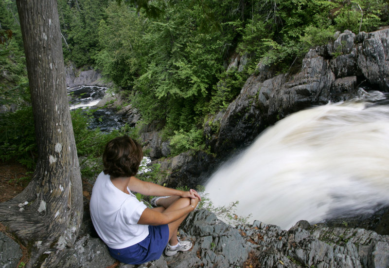 A visitor gets a close view of Moxie Falls in Moxie Gore, off Route 201 near The Forks. At 90 feet, it is one of the highest waterfalls in Maine. The state’s highest waterfall is 108-foot Katahdin Stream Falls in Baxter State Park.