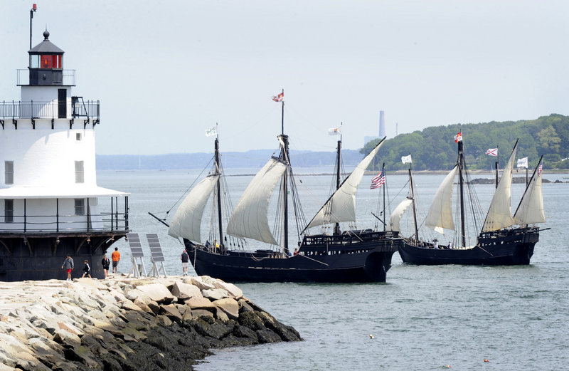 Replicas of the Pinta, left, and the smaller Nina navigate past Spring Point Ledge Lighthouse as they arrive in Portland Harbor on Wednesday for a five-day visit.