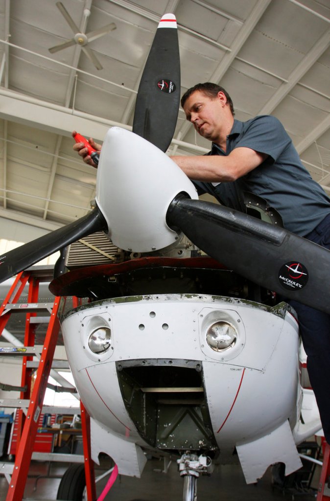 At Northeast Air in Portland, mechanic Will Andrews works on a plane Wednesday. On July 1, Maine ends the 5 percent sales taxes on aircraft parts. ”We know our business is going to go up,” says a Maine Aviation official.