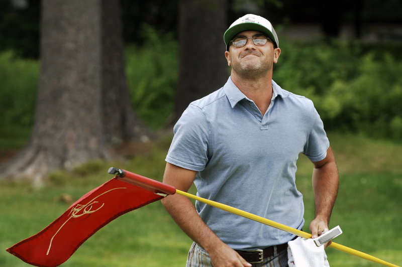Michael Carbone allows himself a winner’s grin after John Hickson’s missed par putt on the first hole of a three-way playoff clinches Carbone’s victory Wednesday in the Charlie’s Maine Open at Falmouth Country Club.