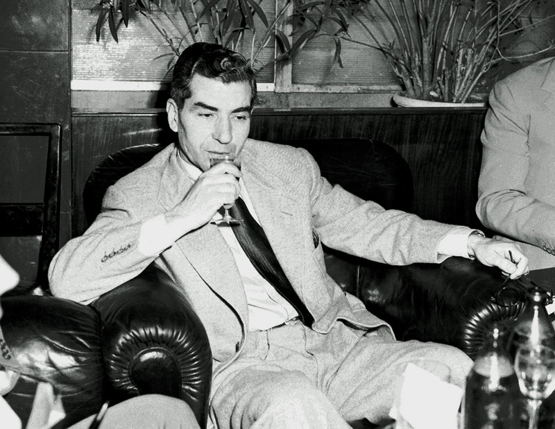 Reputed mobster Charles “Lucky” Luciano, seen in 1946, sips a drink during a news conference in the Excelsior Hotel in Rome. A 3-inch thick official U.S. government file with information about more than 800 Mafia figures has surfaced and will be auctioned by Bonhams New York.
