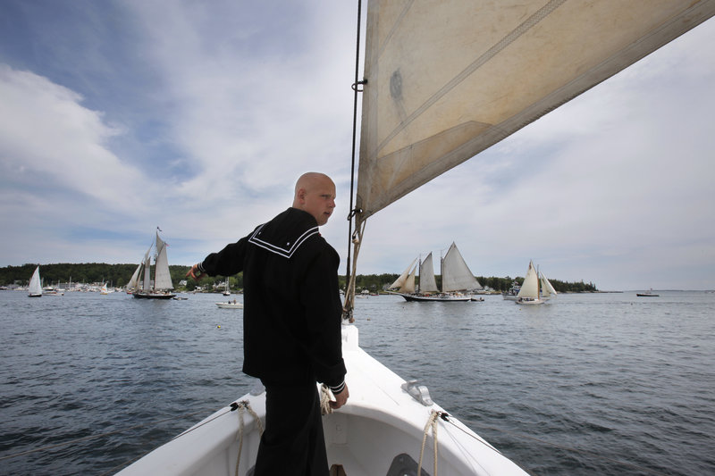 Sea Scout Joseph Holman of Woolwich, a member of Ship 243 of Bath, calls out the location of a mooring buoy while on watch at the bow of the schooner Bowdoin as it sails into Boothbay Harbor during Windjammer Days on Wednesday.