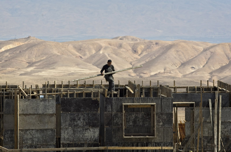 A Palestinian works at a construction site in the Jewish West Bank settlement of Maale Adumim. The Palestinians will drop their demand for an Israeli settlement construction freeze if Israel accepts a U.S. proposal for peace talks, a top official said Thursday.