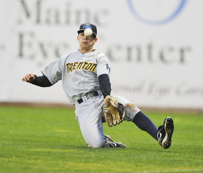 Trenton right fielder Damon Sublett attempts a sliding catch of a pop fly by Portland’s Alex Hassan, but the ball drops for a hit, one of two by Hassan in the Thunder’s 6-2 victory Thursday night at Hadlock Field.
