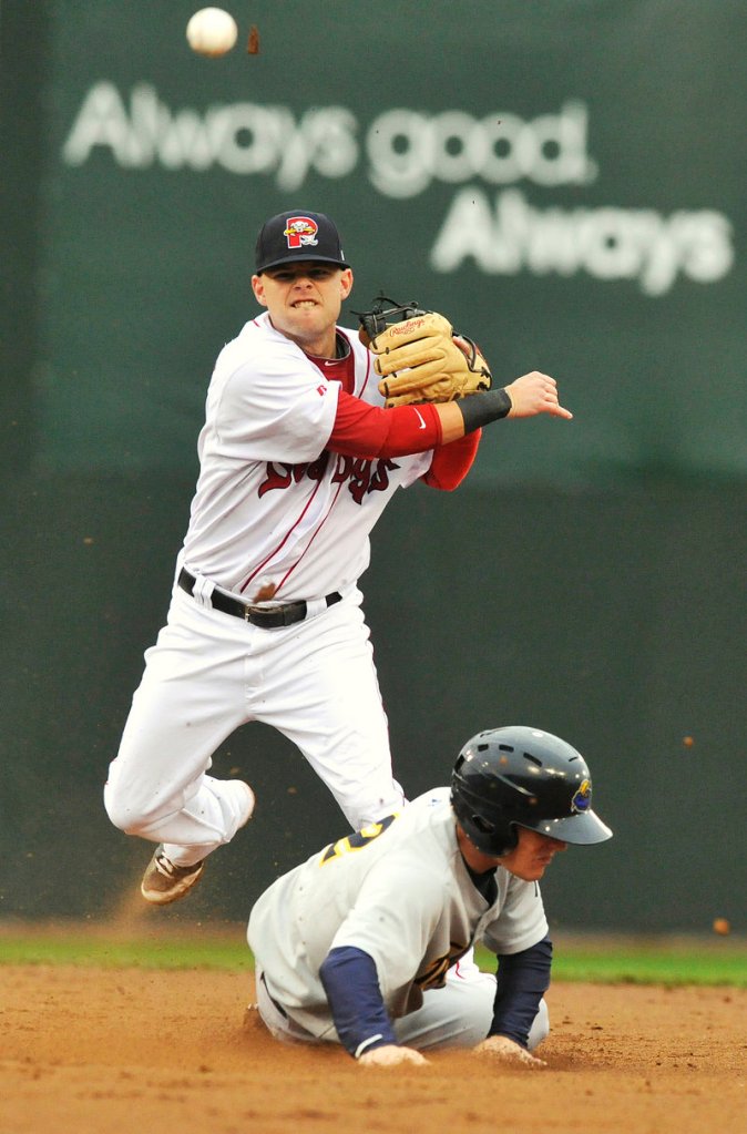 Sea Dogs shortstop Ryan Khoury throws to first over the sliding Corban Joseph of the Thunder to complete a double play in the third inning Thursday night at Hadlock Field.