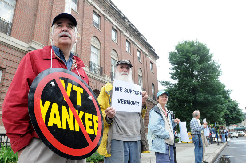 Demonstrators held a vigil outside the federal courthouse in Brattleboro, Vt., Thursday while Vermont Yankee owners asked a federal judge for an order to keep the plant running.