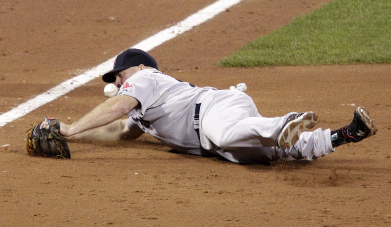 Third baseman Kevin Youkilis of the Boston Red Sox fails to handle a sixth-inning grounder hit by Neil Walker during a 3-1 victory for the Pittsburgh Pirates at home. After losing twice at home to San Diego, Boston has a three-game losing streak.
