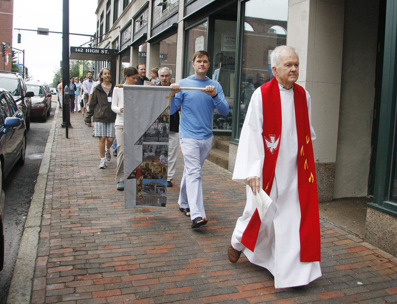 The Rev. Robert Witham leads the Williston-West congregation down High Street in Portland, on its way to a special service to merge with Immanuel Baptist Church as the new Williston-Immanuel United Church.