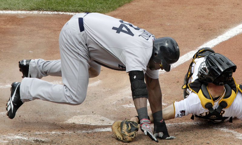 Boston’s David Ortiz gets around the tag of Pittsburgh catcher Eric Fryer in the seventh inning Sunday at Pittsburgh. Ortiz scored on a sacrifice fly by Kevin Youkilis for an insurance run, and Jonathan Papelbon got his 14th save in 15 chances as Boston avoided a series sweep.