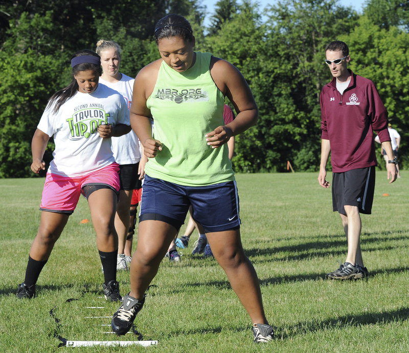 Meghan Agger, who plays basketball and softball, leads a group through the agility ladder during one of the workout sessions at Thornton Academy.