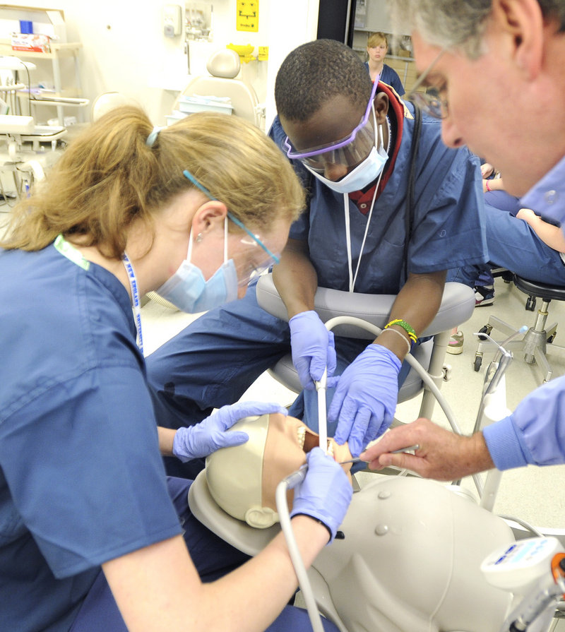 Dr. Lionel Vachon, right, works with Victoria Webber and David Ndayishimiye, both of Portland, on Monday during this week’s Dental Careers Exploration Camp at the University of New England.