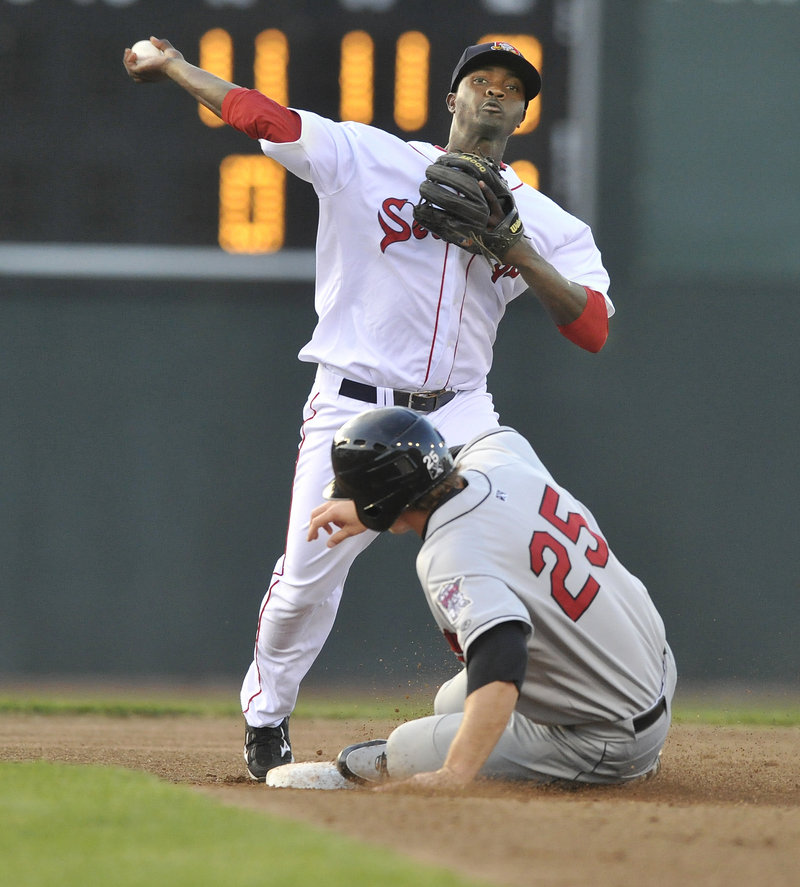 Portland second baseman Vladamir Frias forces out New Britain baserunner Mark Dolenc in the second inning, but his throw is too late for a double play.