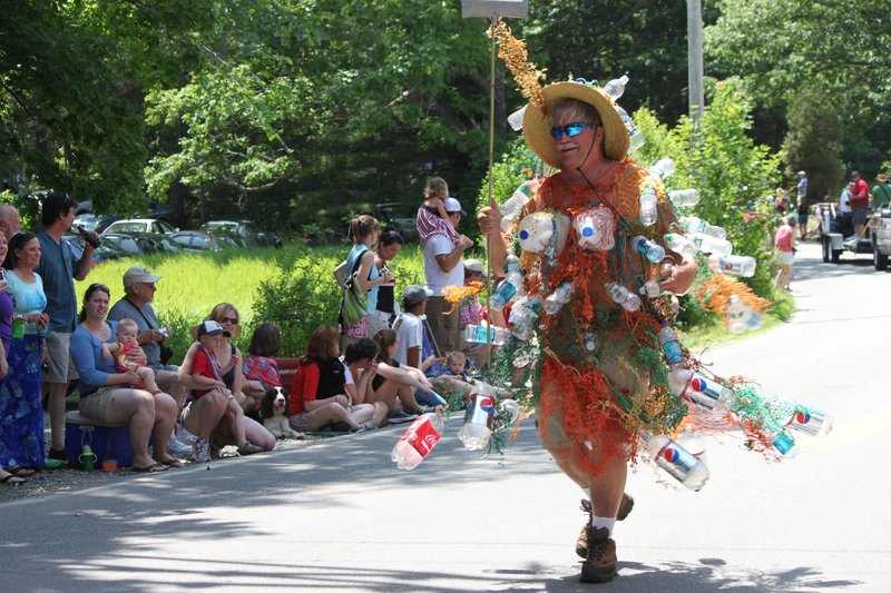"Bottle Bill" marches in a Round Pond Fourth of July parade, an infamously fun-loving event that started small but now draws thousands of spectators.