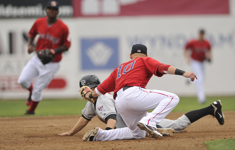 Sea Dogs shortstop Ryan Khoury tags out Brian Dozier of the Rock Cats trying to steal second base during the first game of a doubleheader Tuesday night at Hadlock Field.